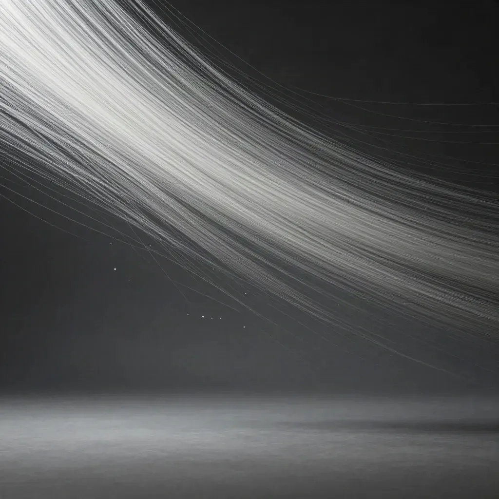 Silver particle streams bloom in graphite haze with empty space below for copy.